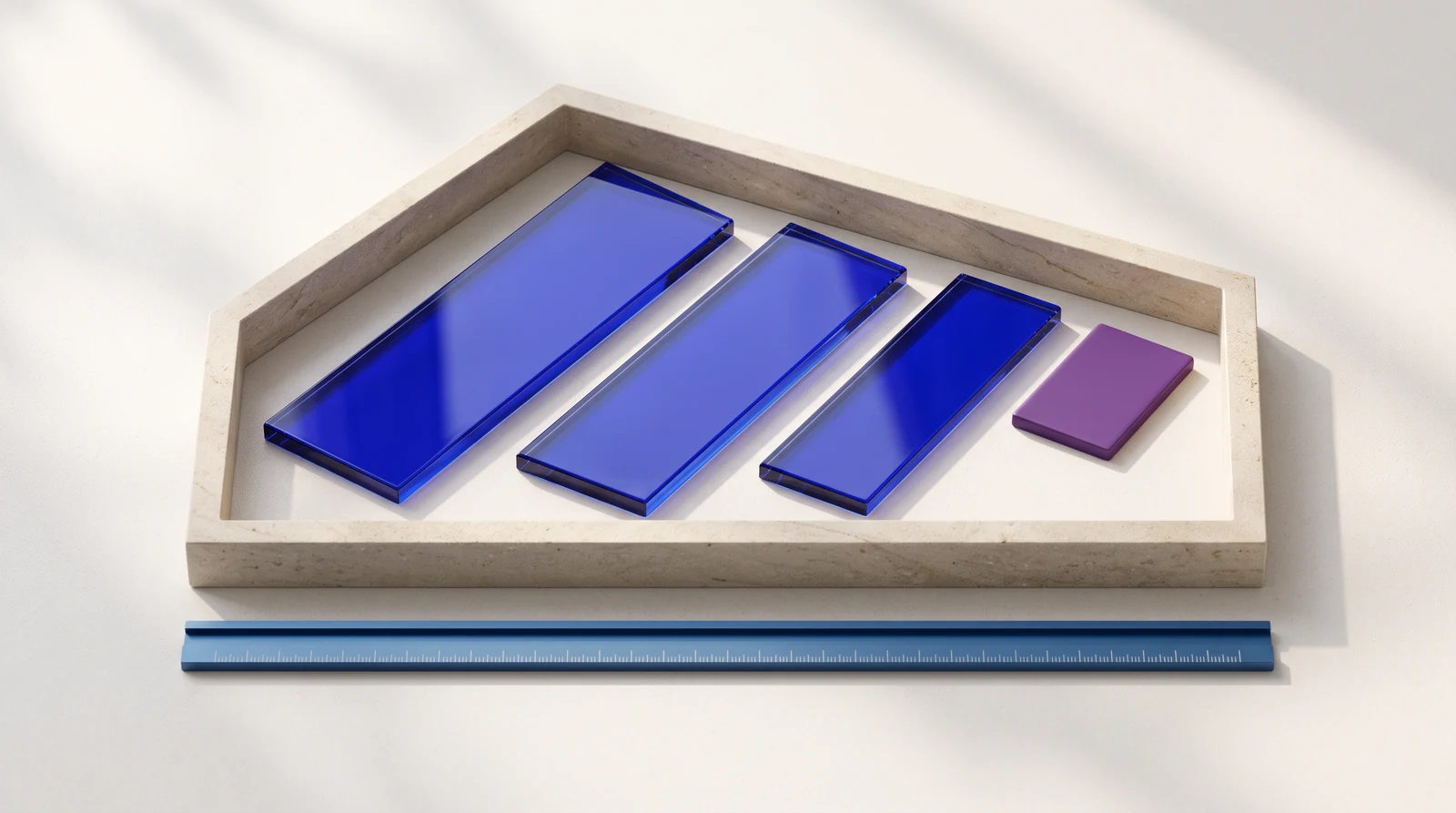 Overhead view of a pale stone boundary containing three cobalt glass panels and a violet tile, with a blue alignment rail beside it — an illustration of a defined scope.
